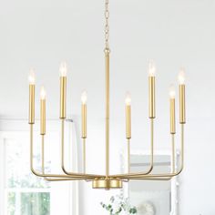 a large chandelier with candles hanging from it's sides in a dining room