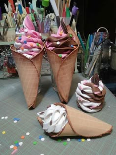 two ice cream cones sitting on top of a table