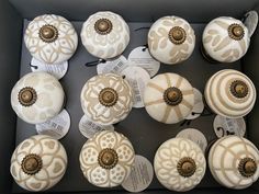 twelve decorative knobs are arranged in a box