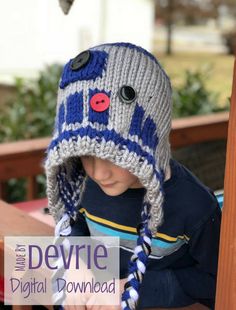 a young boy wearing a knitted hat with buttons