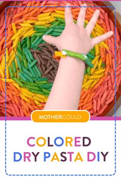 a child's hand reaching for colored pasta in a bowl with the words mothercould