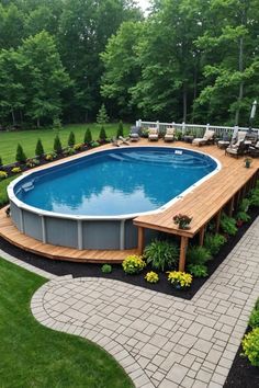 an above ground swimming pool surrounded by landscaping