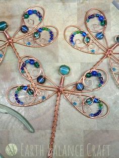 a dragonfly made out of wire and glass beads