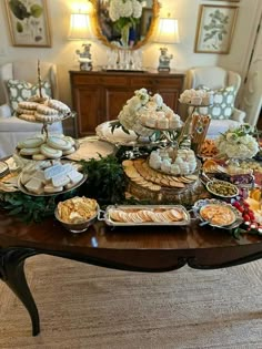 a table topped with lots of food and desserts