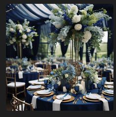 a table set up with blue and white flowers