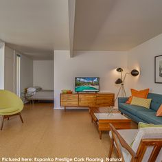 a living room filled with furniture and a flat screen tv sitting on top of a wooden table