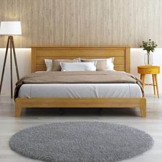 a large bed sitting next to a wooden night stand