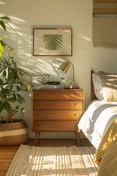 a bedroom scene with focus on the dresser and bed, plants in basket next to it