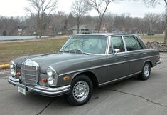 an old mercedes parked in a parking lot