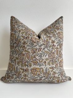 a decorative pillow on a white surface