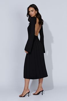 Romantic and dreamy, JUNIPER is the timeless beauty of an old soul. A boat-necked maxi dress with long, flared sleeves and a raw hem, she comes off as modest and full-coverage. But don’t let her catch you off-guard — there’s a bit of spice to her, too! Her low, keyhole back opening shows plenty of skin. With the right shoes, hair, and accessories, Juniper can be as showy and sensual as you need her to be. But, for the most part, she’s a classic. Delicate heels like our Caitlin Diamante Rope Heel Long Flare Sleeve Dress, Chic Black Long Sleeve Midi Dress, Meshki Juniper Dress, Winter Black Knit Midi Dress, Black Long Sleeve Midi Dress Relaxed Fit, Black Winter Dress, Delicate Heels, Black Long Sleeve Viscose Midi Dress, Black Long Sleeve Knit Midi Dress