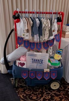 a toy wagon with clothes on display at a baby shower