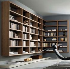 a room with bookshelves and a chair on the floor in front of it