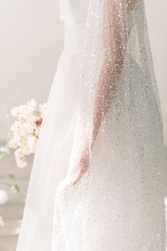 a woman in a white wedding dress and veil