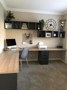 a home office with two desks and shelves on the wall