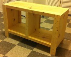 a wooden bench sitting on top of a checkered floor