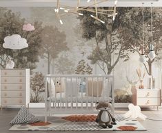 a baby's room with a crib, dressers and wallpaper that has trees on it