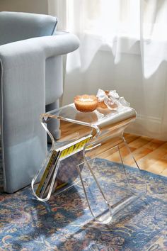 two donuts sitting on top of a clear tray next to a blue couch in a living room