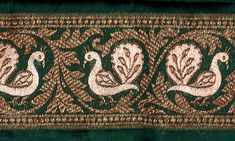 an image of two peacocks on a green and brown background with gold trimming