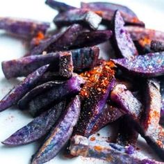 purple potatoes with seasoning sitting on a white plate