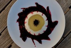 a white plate topped with food on top of a wooden table