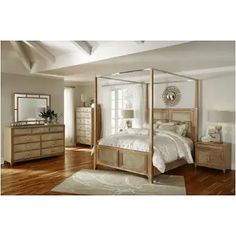 a bedroom with a bed, dresser and mirror