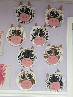 paper plates with farm animals on them are arranged in a row against a purple wall