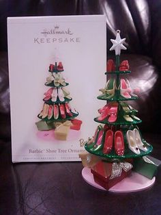 a christmas tree ornament next to a card on a leather couch with its box