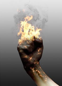 a hand with fire on it holding something in the air