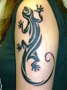 a black and white tattoo on the arm of a person with a lizard on it