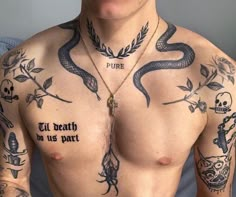 a shirtless man with tattoos on his chest