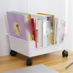 there is a book rack on wheels with books in it