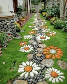 the grass is decorated with flowers and rocks