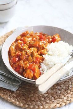 a bowl filled with rice and meat on top of a table