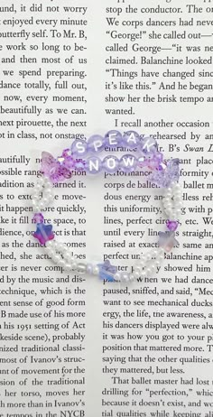 a book page with an image of a purple beaded bracelet