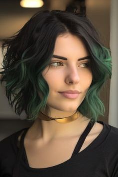 A classic shag with hints of emerald green adds a funky twist to a retro style. The emerald green streaks peek through layers, creating an unexpected pop of color. Click here to check out more stunning black hair with highlights ideas. Dark Green Highlights Curly Hair, Black To Green Ombre Hair Short, Green Face Frame Hair, Blonde And Green Highlights, Dark Green Hair Highlights Brunettes, Green Tipped Hair, Black Hair With Green Ends, Black And Green Short Hair, Dark Green Hair Streaks