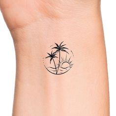 a small palm tree tattoo on the left side of the wrist is shown in black ink