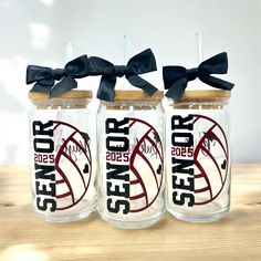 three boston red sox mason jars with black bows on the top one is clear and two are empty