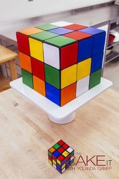 a cake made to look like a rubik cube on top of a wooden table