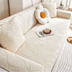 a white couch with pillows on top of it