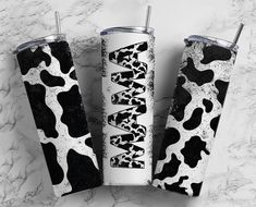 two black and white tumblers sitting next to each other on a marble counter top