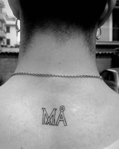 a man with a tattoo on his neck and the word am written in small letters