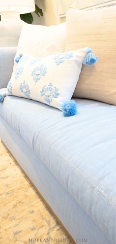 a blue couch with two pillows on it