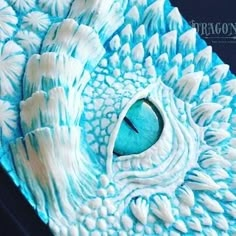 a close up view of a blue and white dragon's eye on a paper mache