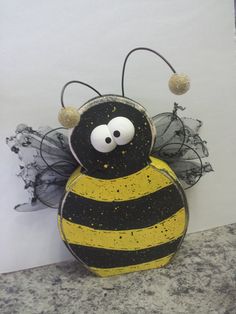 a yellow and black bee statue sitting on top of a counter