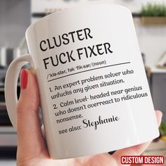 a person holding a white coffee mug with the words clusterer, fyick fixer on it