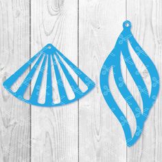 two blue christmas ornaments on white wood