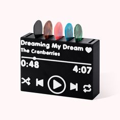 a black box with four different colored magnets in it's center and the words dreaming my dream on top