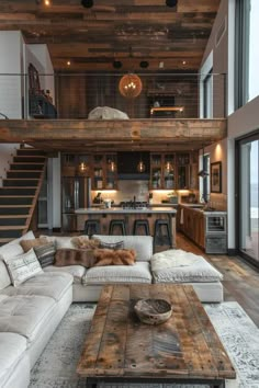 a living room filled with lots of furniture and a fire place in front of a staircase