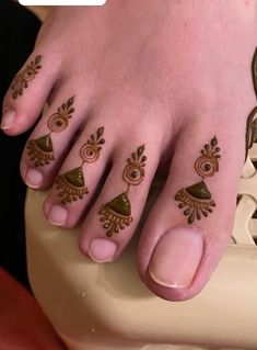 a person with henna tattoos on their feet